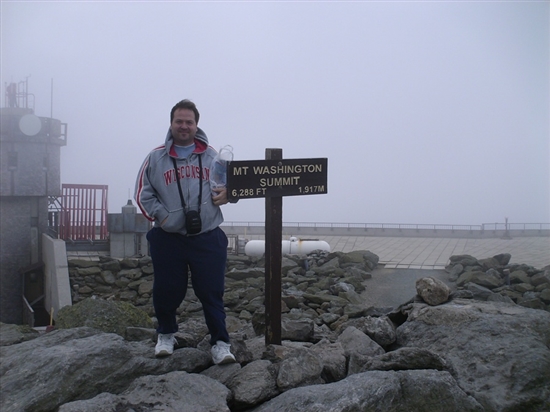 Todd at the top of Mt. Washington. You can see that it is really cloudy and windy, you can't see the moutains in the background, like early pictures.