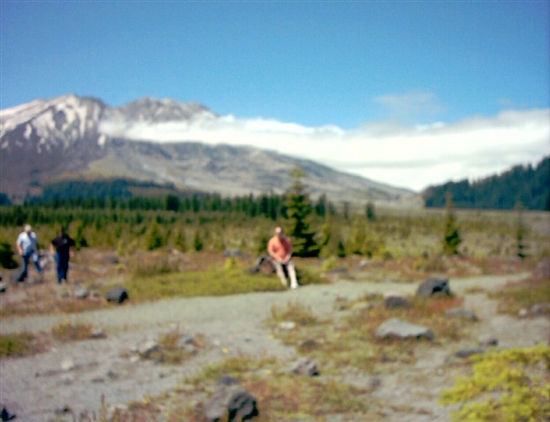 Todd in orange, in front of Mount St. Helens.