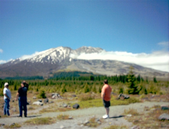 Todd in orange, in front of Mount St. Helens.